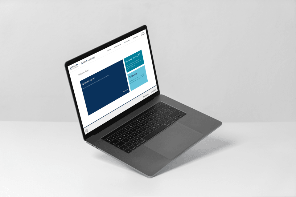 A mockup of a UKHO-branded website dashboard on a Mackbook pro